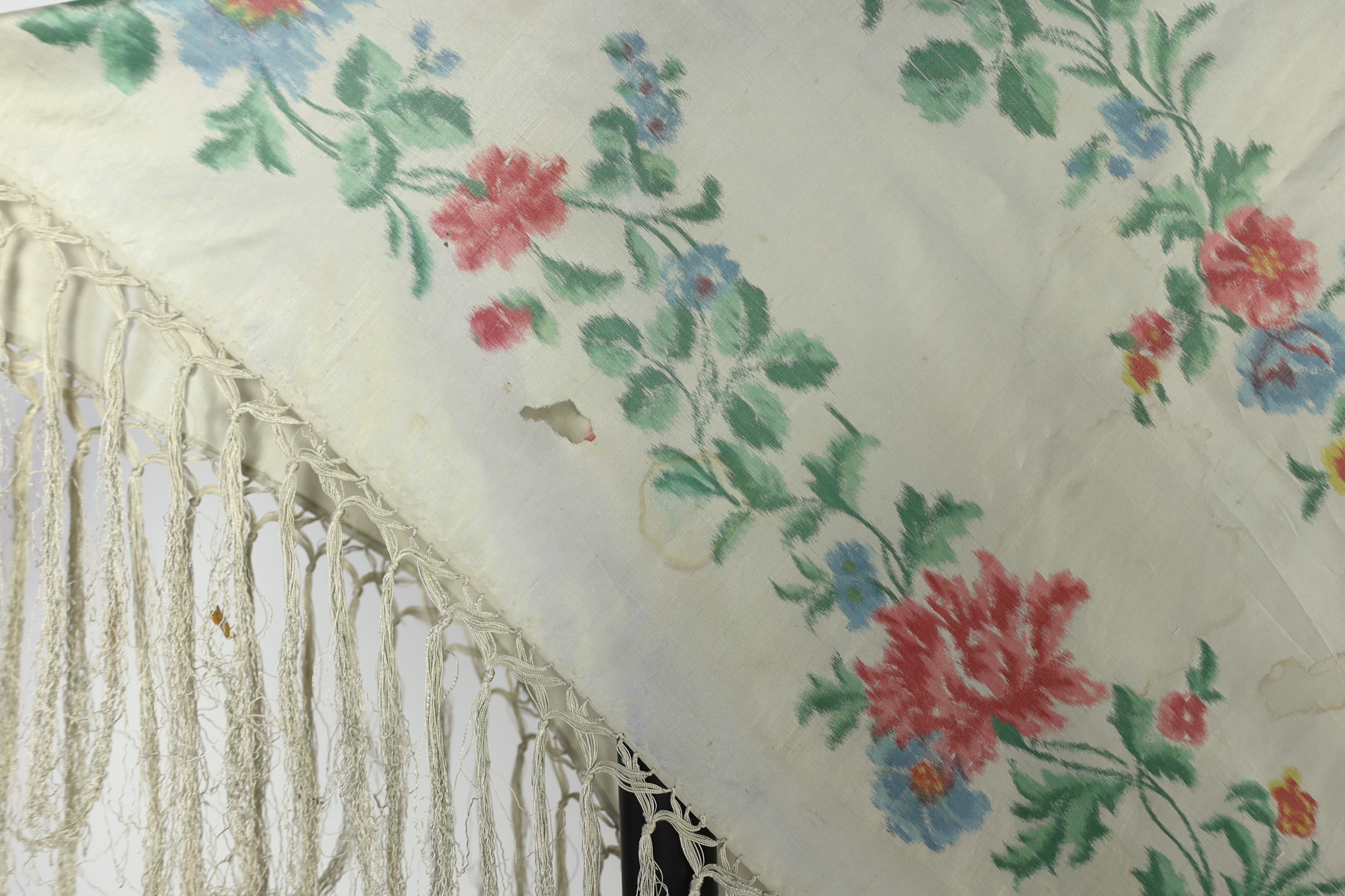 A French silk shawl, c.1800-1840, of a type modelled by Madame Recamier in the painting by François Gerard, printed on the warp thread into a rose pattern, with long fringing, 174 x 170cm